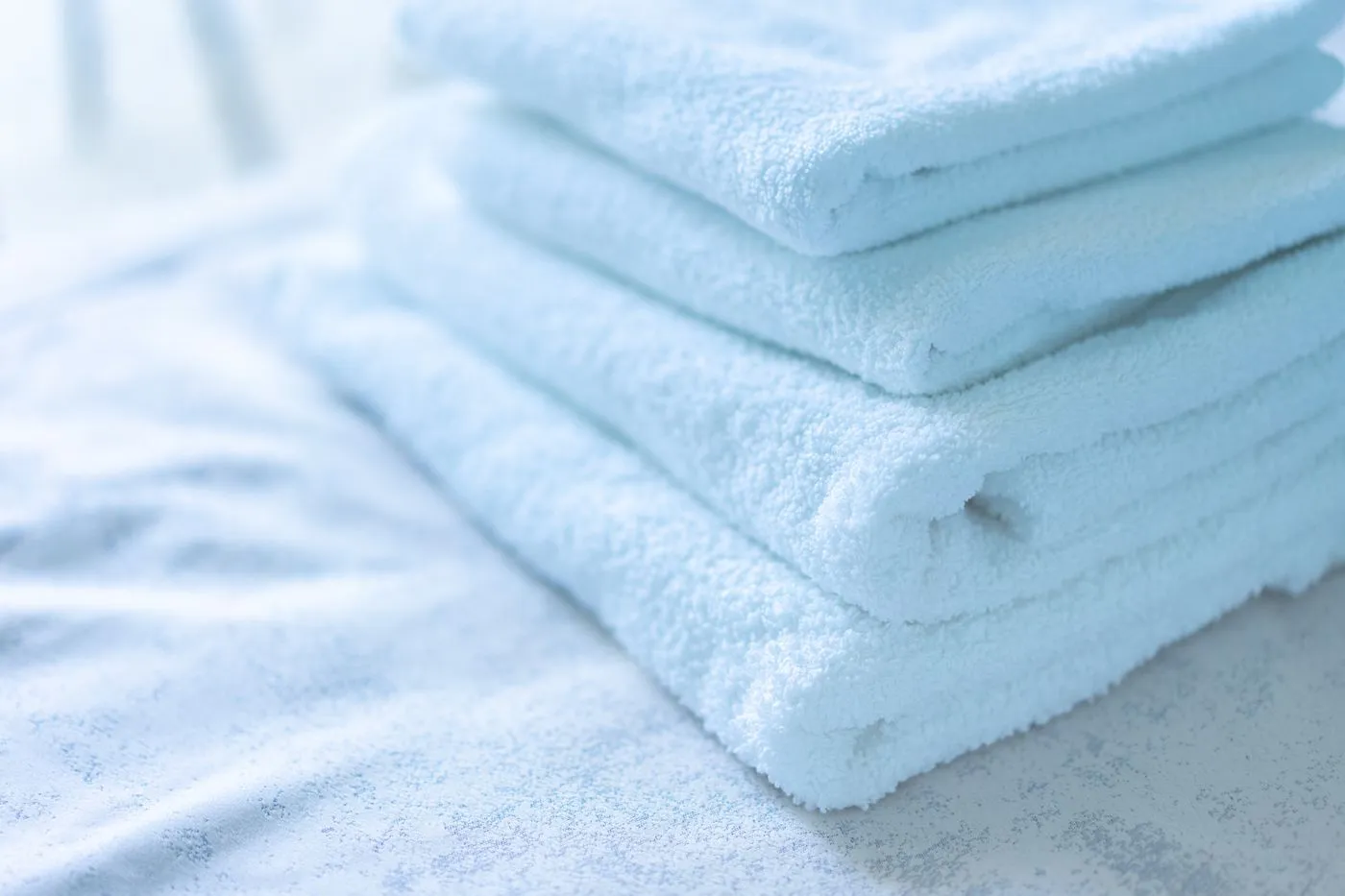 Clean white cotton towels stacked together