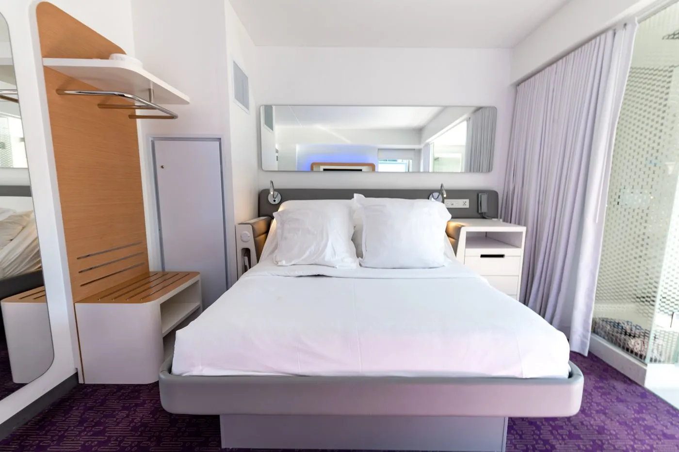 Bedroom with white bedding and simple furniture
