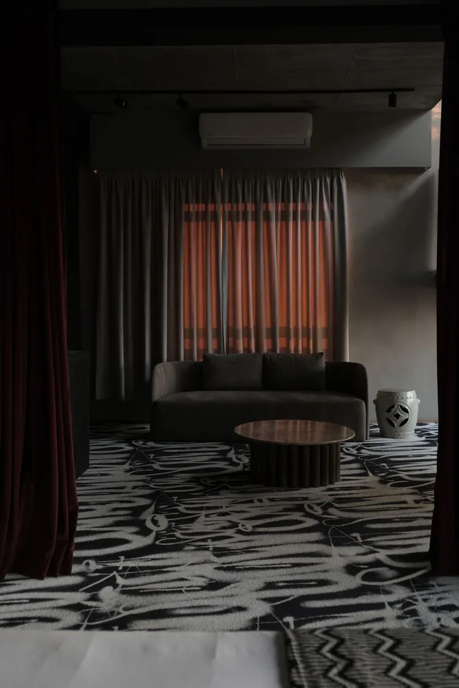 Living room with a patterned rug and curtains