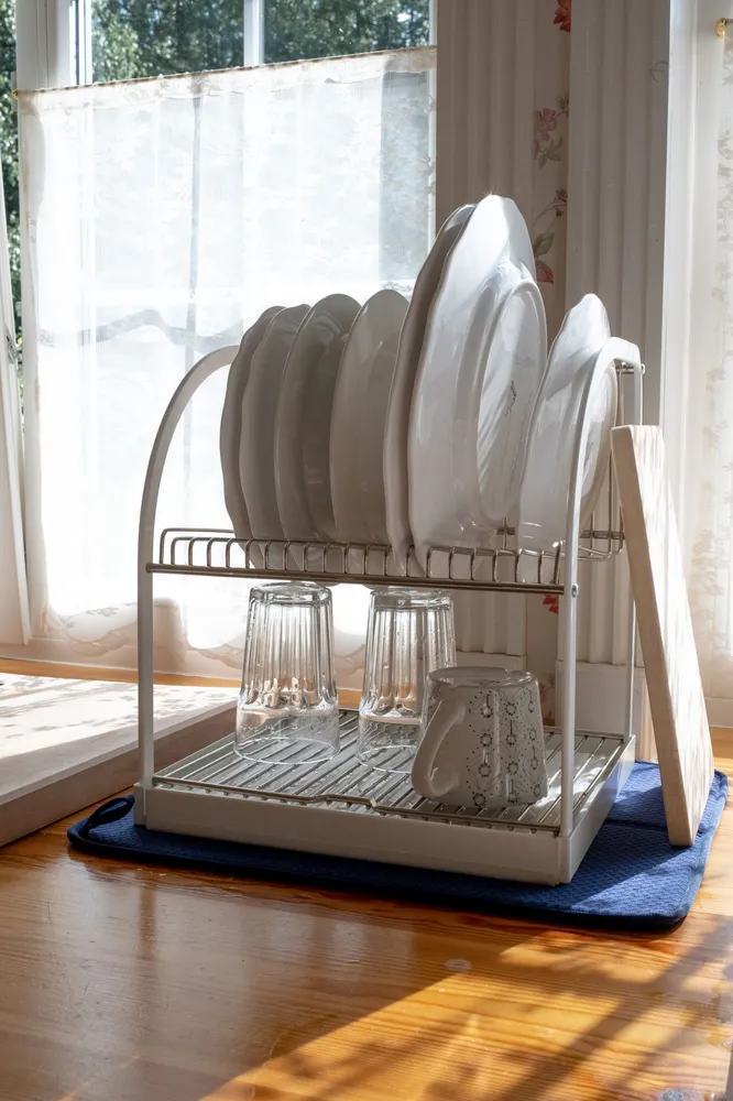 Plates and glasses on a sunlit dish rack